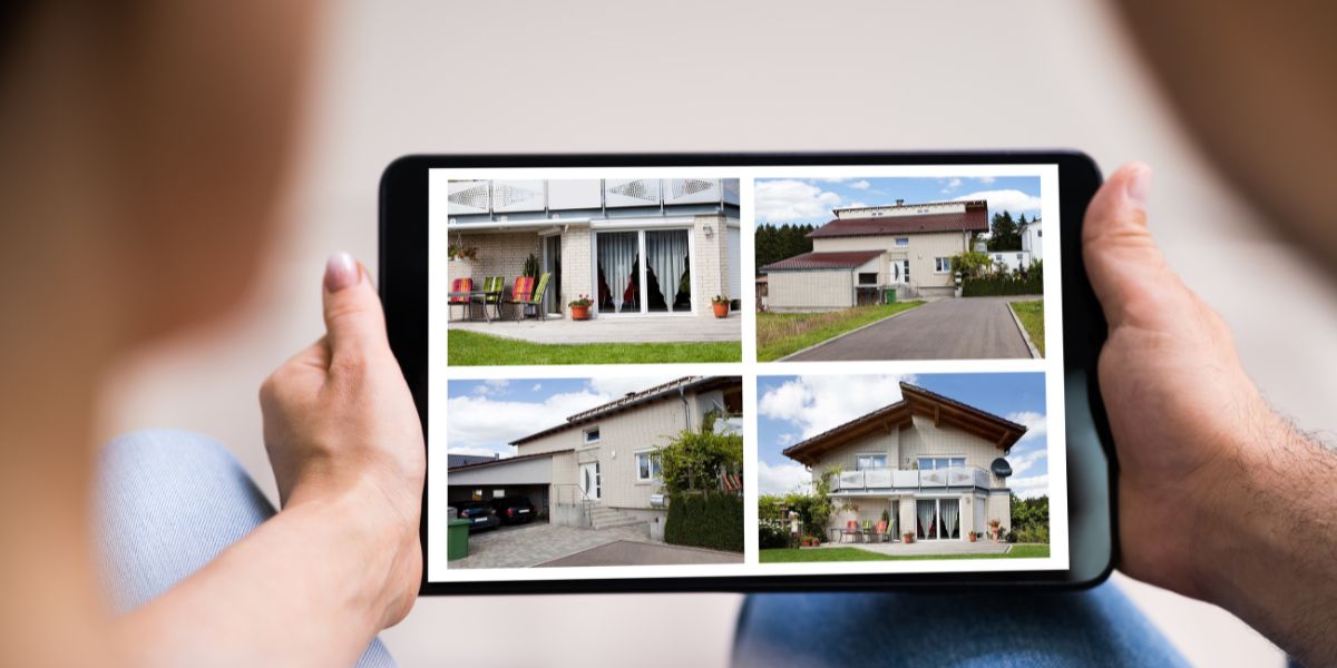 Person holding a tablet displaying four photos of different houses.