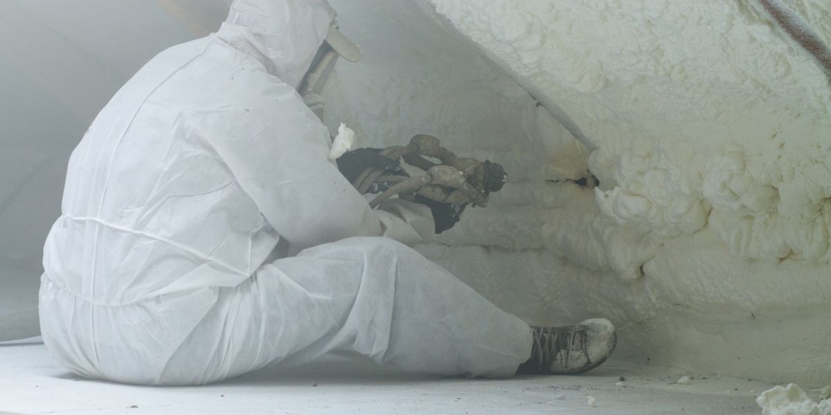 man working in attic, working with spray foam